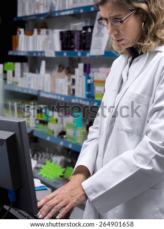 Women, pharmacy assistant, getting data into the computer