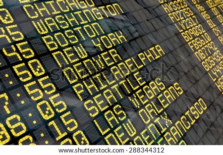 Close-up of an airport departure board to usa cities destinations, with environment reflection.Part of a series.