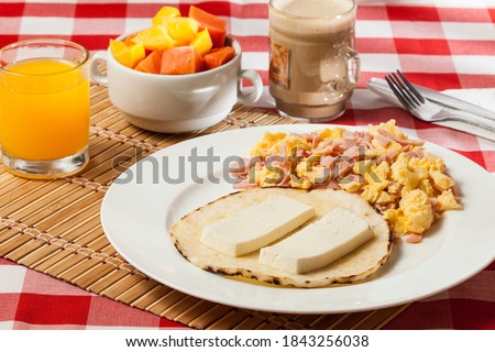 Arepa for breakfast, cheese and scrambled egg, a traditional Colombian dish. Foto stock © 