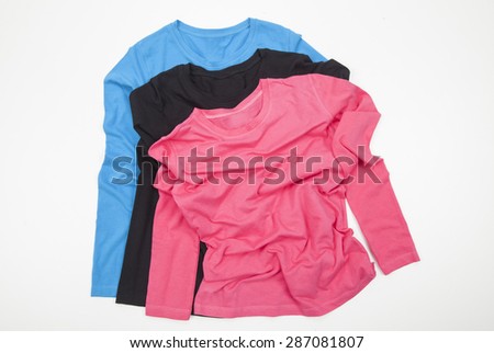 three different unisex long sleeve shirts Color folded on white background