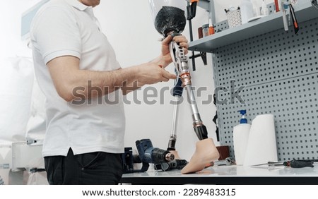 Similar – Image, Stock Photo Crop worker assembling mechanism in workshop
