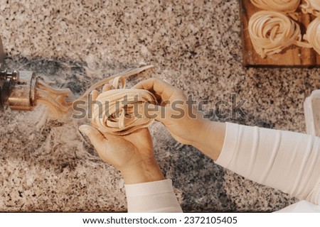 Image, Stock Photo Anonymous female cook rolling dough while using pasta machine