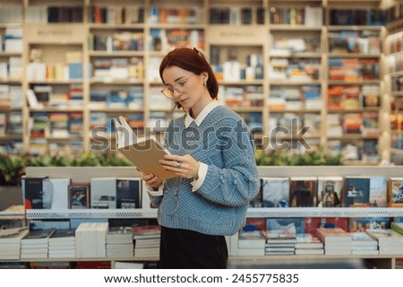 Image, Stock Photo Woman reading a book in cafe sitting at wooden table with flowers in a vase. Romantic date with a book. Brown vintage neutral color background. Literature & Library, book lover spending leisure time.