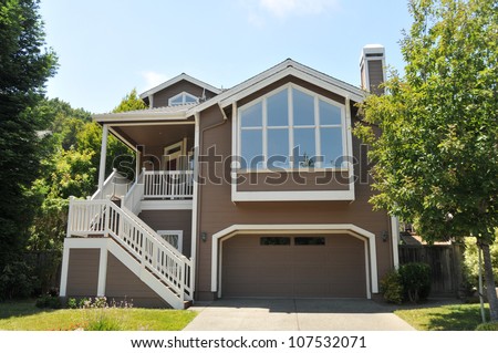 Single family house with two levels and a short driveway.