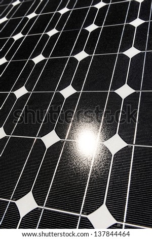 Some solar panels reflect the sun with patterns in the panels.
