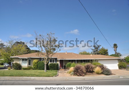 Yellow single family house with grass in front has wires and cables coming off the roof