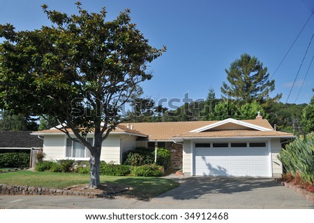 House with large tree in front, wires to house
