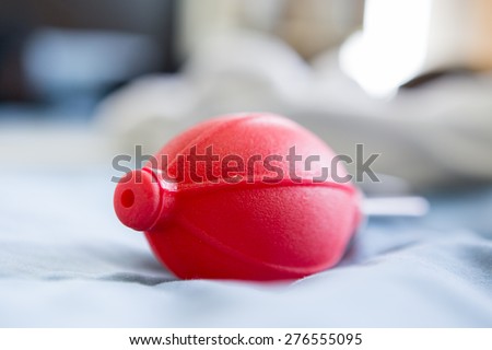 red rubber air blower pump with blurred background