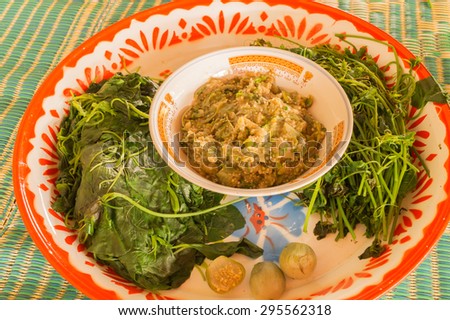 Big tray of steam vegetable and dipping paste made from eggplant in Thai and Lao food style