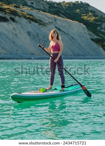 Image, Stock Photo Woman with paddleboard on shore in sea