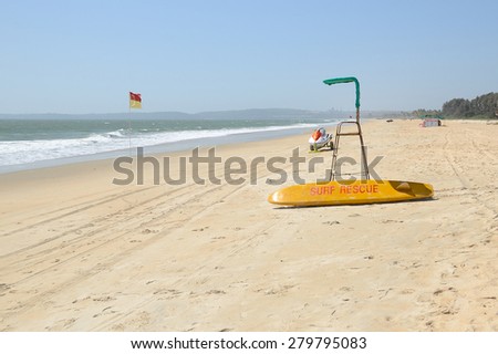 Beach Surf Rescue surfboard, flag and chair.