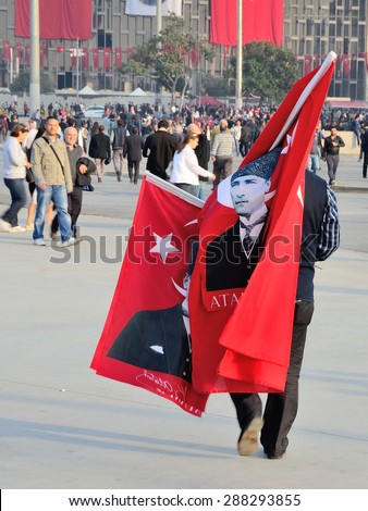 A person with flags and portraits of Ataturk in  Istanbul, Turkey on October 29, 2013.