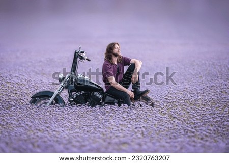 Similar – Image, Stock Photo Young long hair motorbike guy smiling to camera while checking his phone while sitting on his old school motorbike during a break from the road route. Liberty life, young man heavy metal, white tshirt