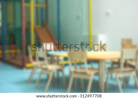 Blurred classroom in a kindergarten with little chairs for the children