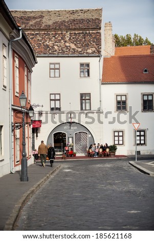BUDAPEST, HUNGARY - OCTOBER 19, 2013: Tourist sitting at street terrace in front of the restaurant. Budapest has many cafes and restaurants all over the city.