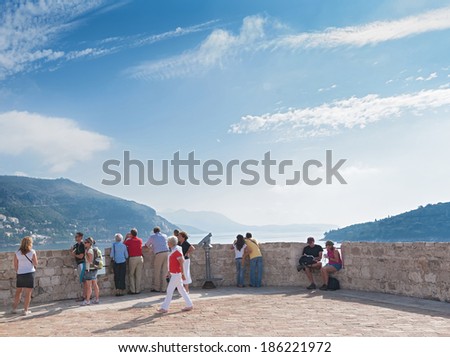 DUBROVNIK, CROATIA - OCTOBER 10, 2009: Tourists on old city walls which have been considered to be amongst the great fortification systems of the Middle Ages.