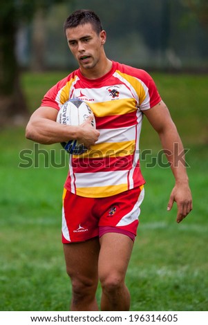 ZAGREB, CROATIA - OCTOBER 12, 2013: Friendly rugby match between RC Mladost (red-yellow jersey) and Austrian National Team (black jersey).  Unidentified Mladost player with ball