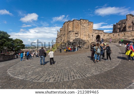 EDINBURGH, SCOTLAND: AUGUST 3, 2014: Tourists walking inside the Edinburgh Castle. Castle is most popular tourist attraction in Scotland.