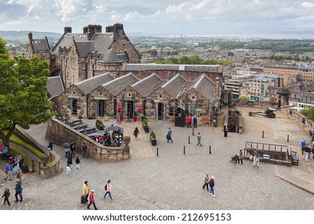 EDINBURGH, SCOTLAND: AUGUST 3, 2014: Tourists walking inside the Edinburgh Castle. Castle is most popular tourist attraction in Scotland.