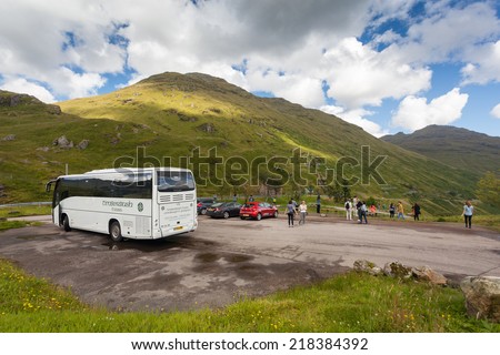 GLEN CROE, SCOTLAND - AUGUST 7, 2014: Tourists at Glen Croe, glen in the heart of Arrochar Alps.