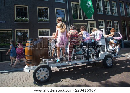 AMSTERDAM - NETHERLANDS: AUGUST 1, 2014: Girls having bachelorette party on beer bike.
