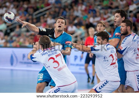 ZAGREB, CROATIA - OCTOBER 11, 2014: EHF Men\'s Champions League, match between HC Zagreb and HC Metalurg. Naumce MOJSOVSKI (18) blocked by Sandro OBRANOVIC (37).