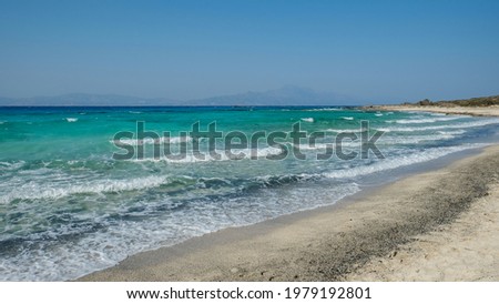 Waves going one after another on the white sand shore of the Golden beach at Chrissi island, Greece