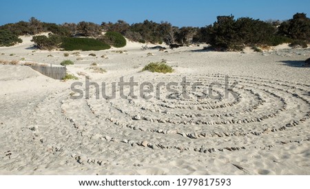 Huge circles made of stones on a white sand beach of Chrissi island, Greece
