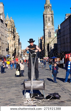 EDINBURGH, SCOTLAND -  18 APRIL, 2015: Street Artist known as Todd Various performs with ropes on the Royal Mile, Edinburgh