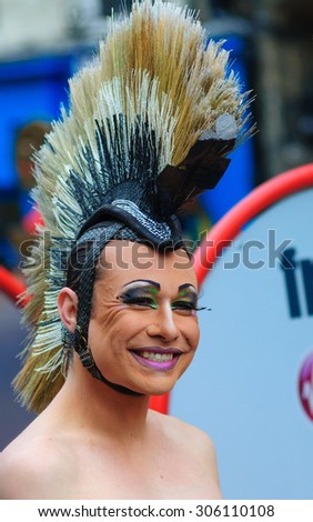 EDINBURGH, SCOTLAND - AUGUST 8, 2015: Dancer from the Okareka Dance Company on the Royal Mile during the Edinburgh International Fringe Festival