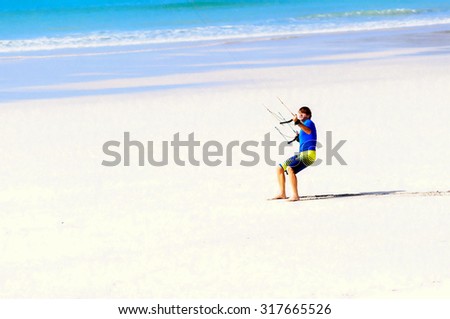 Digital oil pastel sketch from a photograph of a paraglider dressed in tee shirt and shorts, barefoot on a beach, holding the reins of a parachute and being dragged along the sand
