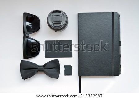 Business set on white background with glasses, tie, business card, memory card and notebook