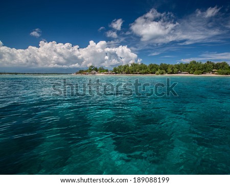 Tropical sea with turquoise water and green island on the horizon. Gili Trawangan, Indonesia
