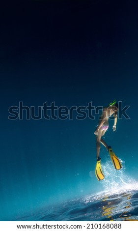 Underwater shot of the lady freediving in a sea