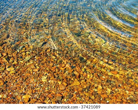 Bottom of the sea with ripples on water surface