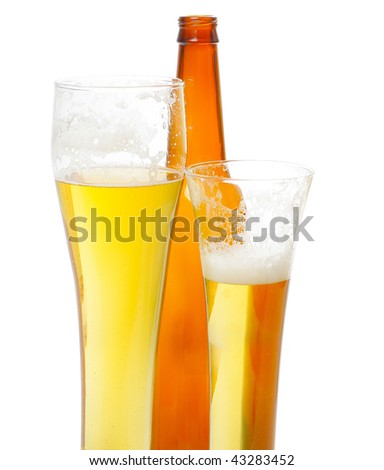 Beer with foam in tall glasses and bottle