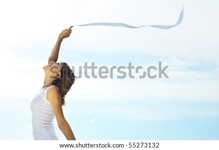 Young woman with ribbon over clear sky background