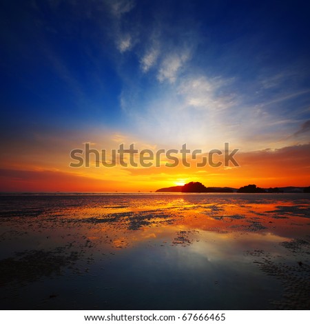 Sunset over beach during ebb