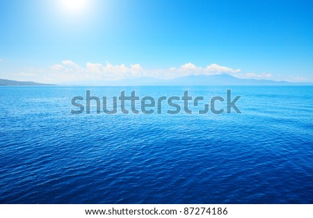 Tropical blue sea and blue sky with sun.