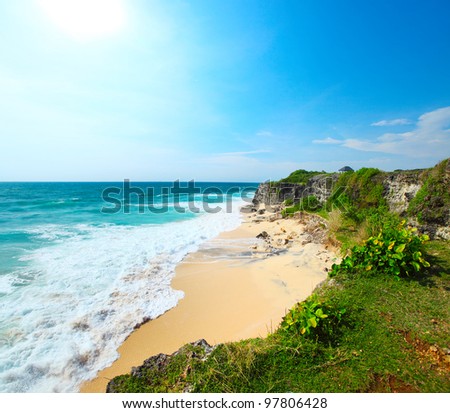 Beach with yellow sand and blue ocean waves. Bali island