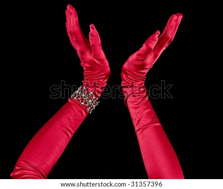 Model\'s arm in long silk formal and elegant red gloves with bracelet