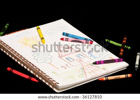 Child\'s crayon drawing of their home with stick figure of them and their dog...crayons laying beside drawing pad.
