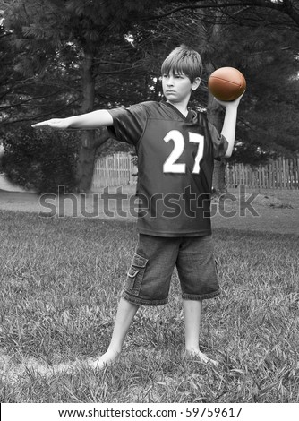 Young boy playing football - black and white images have selected color with football