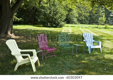Four different lawn chairs in backyard