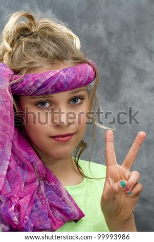 Young girl giving the peace sign while pretending to be in the sixties