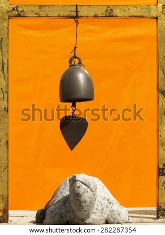 Marble turtle under metal bell in Thai temple
