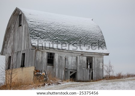 Antique barn with snow on roof