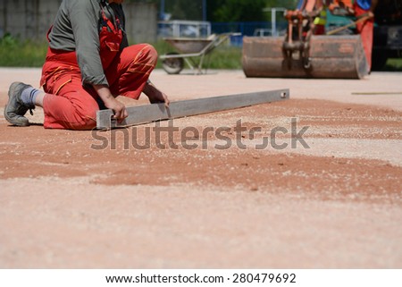 Construction worker on a construction site. Photograph was taken while he was leveling the ground.