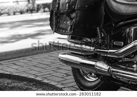 Szeged, Hungary - May 30th, 2015: Photo shoot of Yamaha Drag Star 1100 XVS bike from 2002, closeup shoot of exhaust and saddlebags. 4-stroke SOHC V-twin engine, 1063cc. Black and white photo.