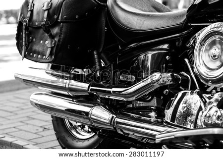Szeged, Hungary - May 30th, 2015: Photo shoot of Yamaha Drag Star 1100 XVS bike from 2002, closeup shoot of a a back wheel,exhaust and body. 4-stroke SOHC V-twin engine,1063cc. Black and white photo.